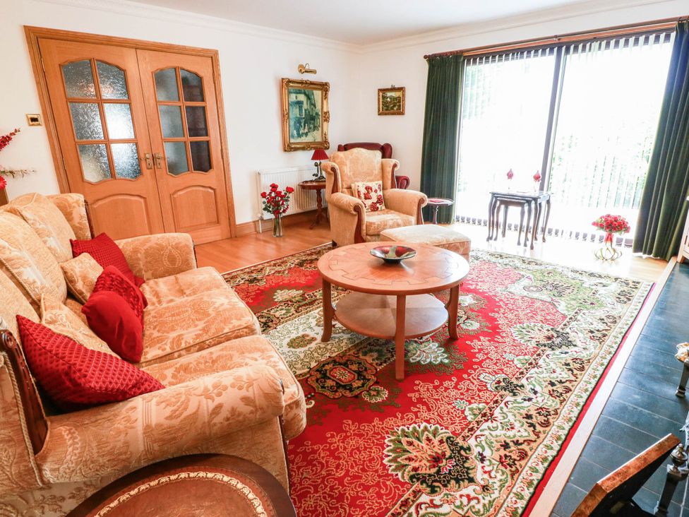 A living room with a sofa and armchair at Wallvilla