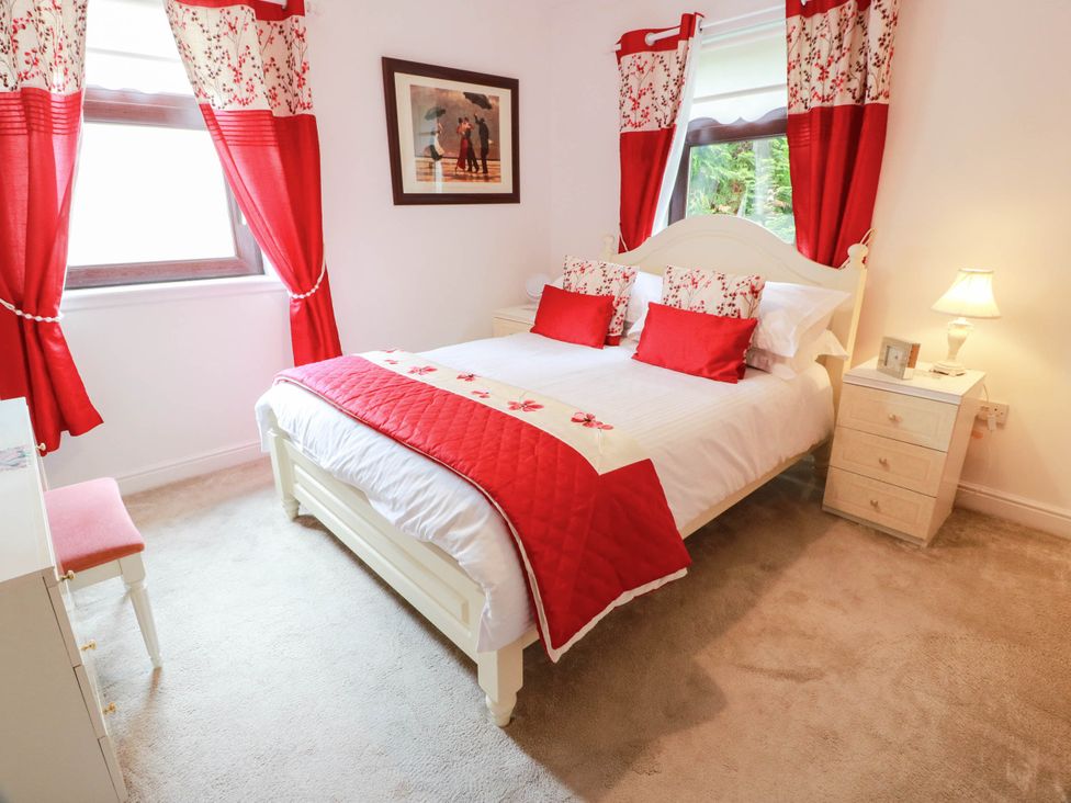 A bedroom with a bed and bedside table at Wallvilla