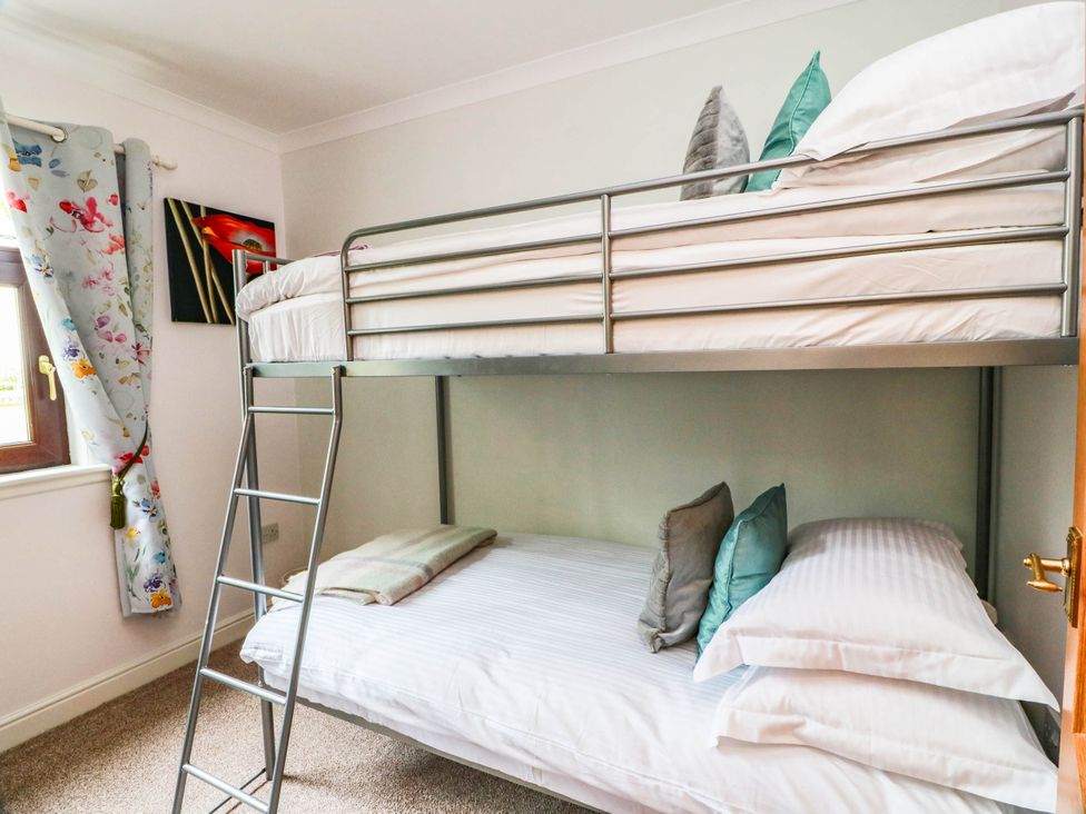 A bedroom with a bunk bed and a window at Wallvilla