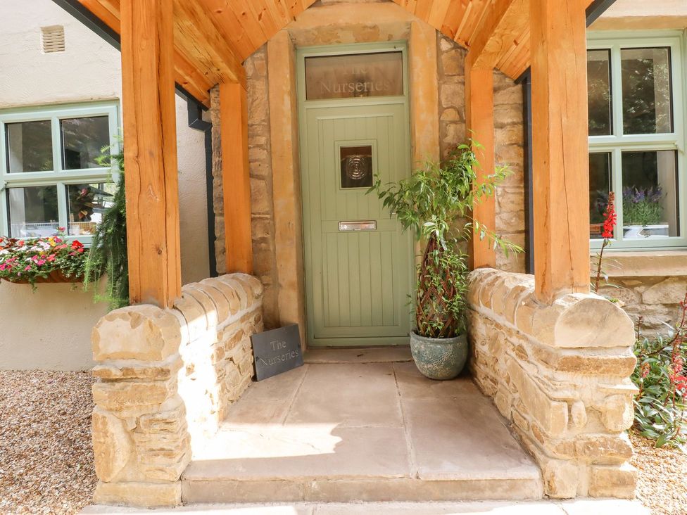 An entrance with a door and stone wall at The Nurseries in Burnley