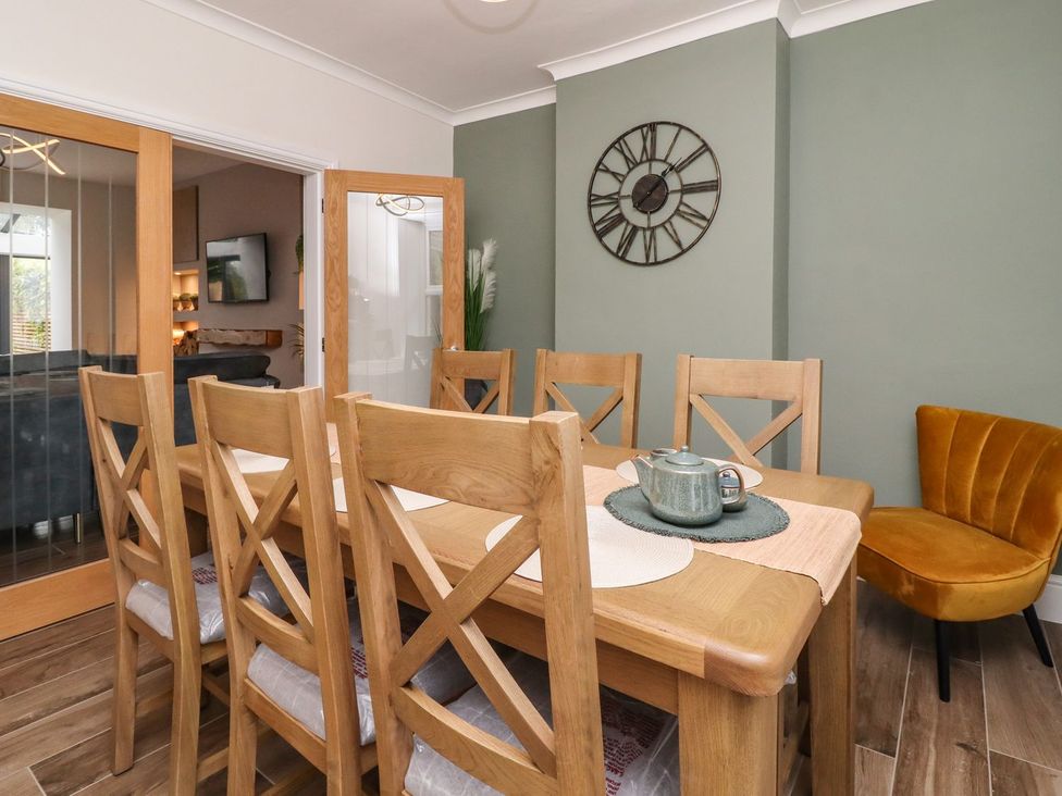 A dining room with a table and chairs at Cottage by the River in Burnley