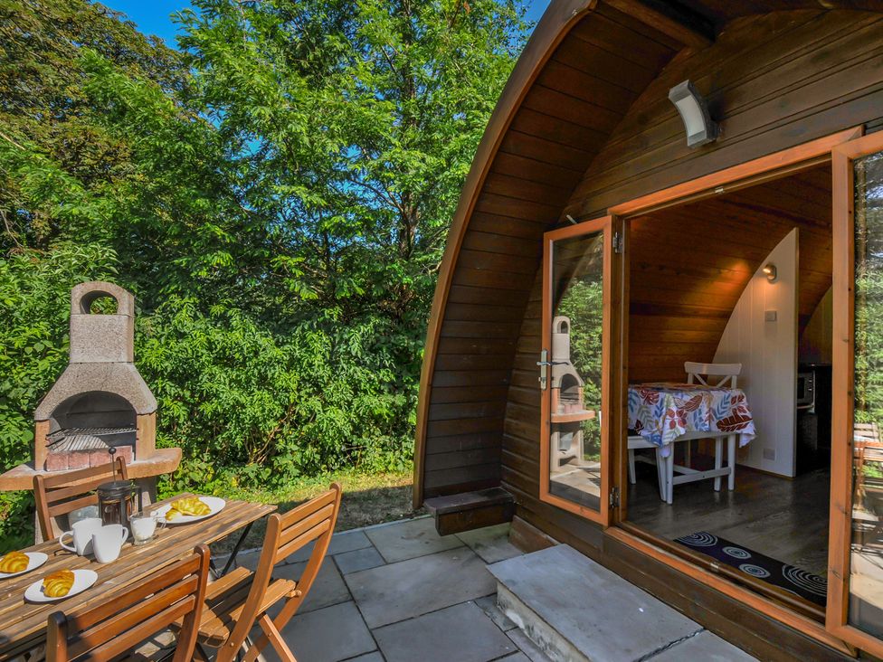 An outdoor seating area with a barbecue grill near Yar Tor in Tavistock
