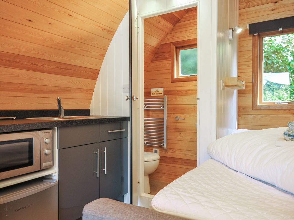 A bedroom with a kitchenette and bathroom facilities at Birch Tor in Tavistock