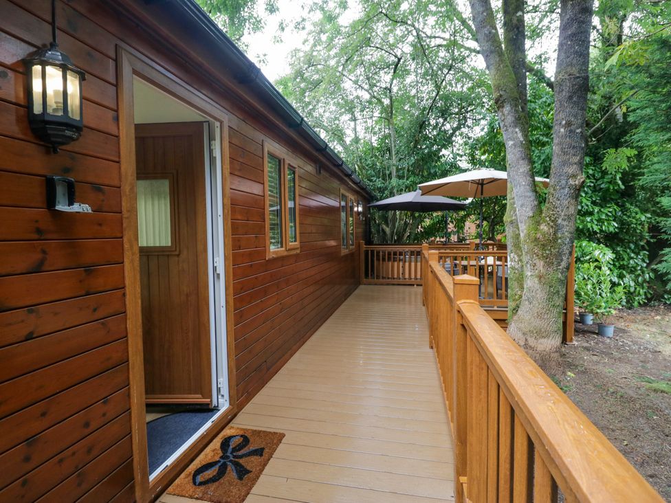 An outdoor area with wooden decking and an entrance at Fir Tree Lodge, White Cross bay on Windermere, Troutbeck Bridge