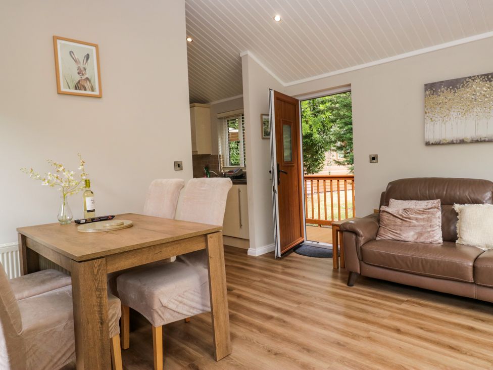 A dining room with a table and chairs at Fir Tree Lodge in White Cross bay on Windermere, Troutbeck Bridge