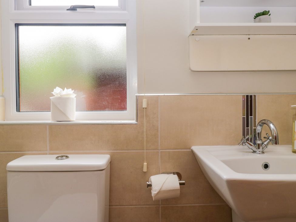 A bathroom with a toilet and sink at Fir Tree Lodge in White Cross bay on Windermere, Troutbeck Bridge