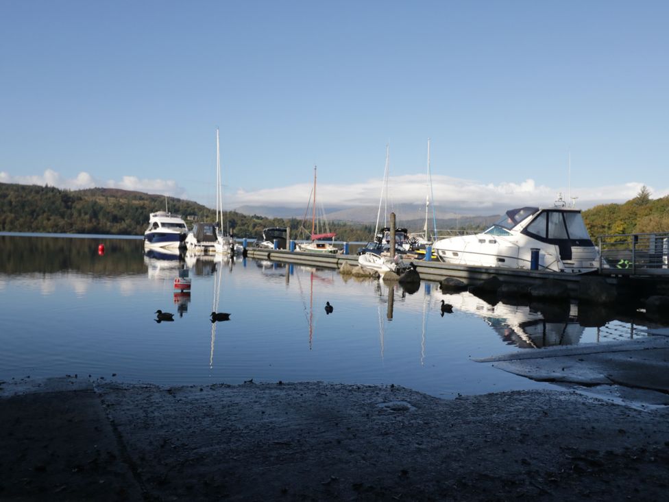A marina with boats and ducks on water at Fir Tree Lodge, White Cross bay on Windermere, Troutbeck Bridge