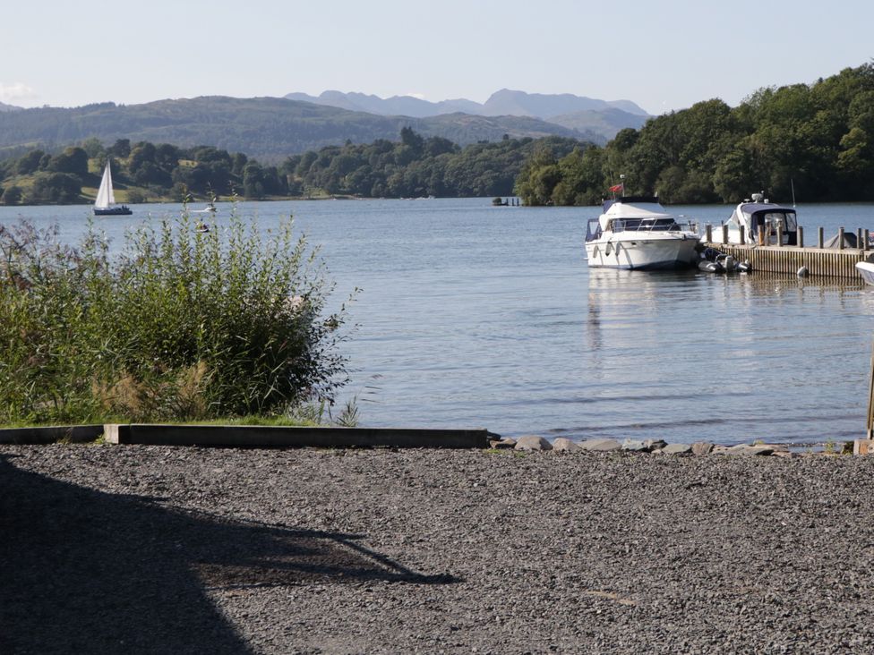A view of water with boats and mountains at Fir Tree Lodge, White Cross bay on Windermere, Troutbeck Bridge