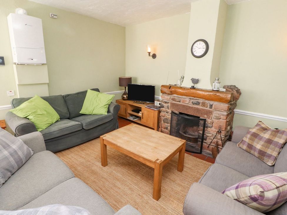 A living room with sofas and a coffee table at Mellfell Cottage near Watermillock