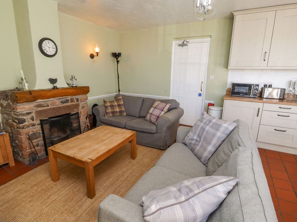 A living room with a sofa and coffee table at Mellfell Cottage near Watermillock