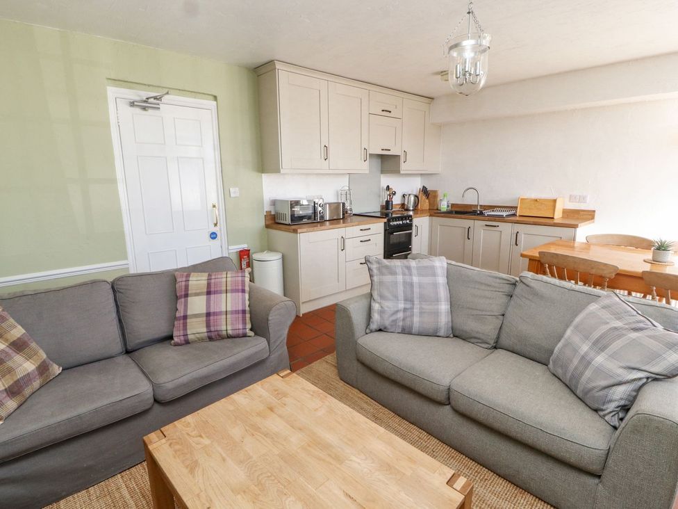 A living room with kitchen and dining area at Mellfell Cottage near Watermillock