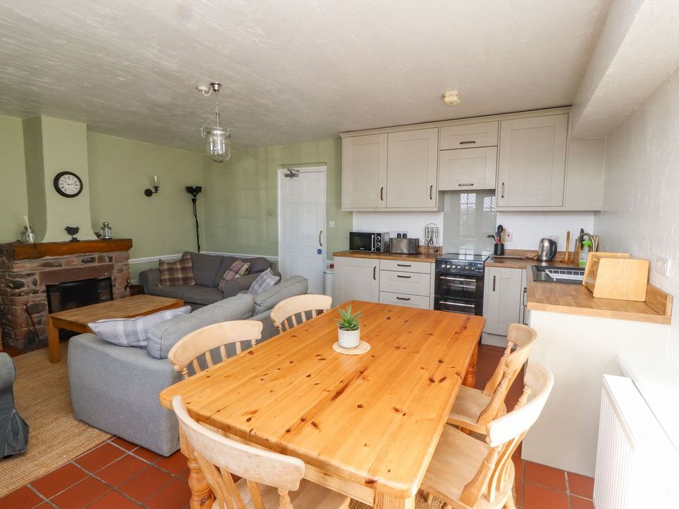 A kitchen with a dining area and seating at Mellfell Cottage near Watermillock