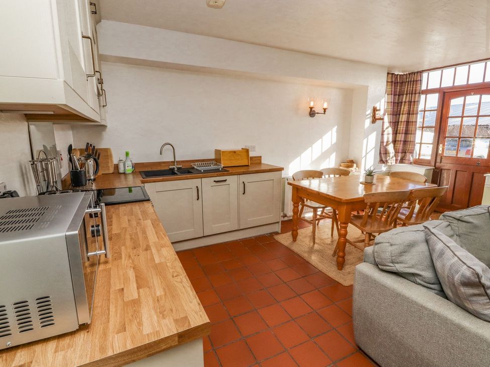 A kitchen with counter space and dining area at Mellfell Cottage near Watermillock
