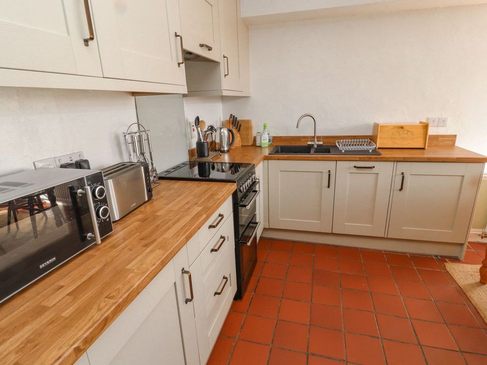 A kitchen with appliances and a sink at Mellfell Cottage near Watermillock