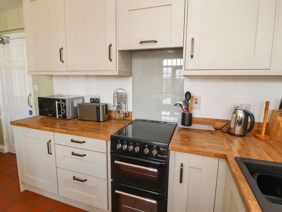 A kitchen with appliances and counter space at Mellfell Cottage near Watermillock