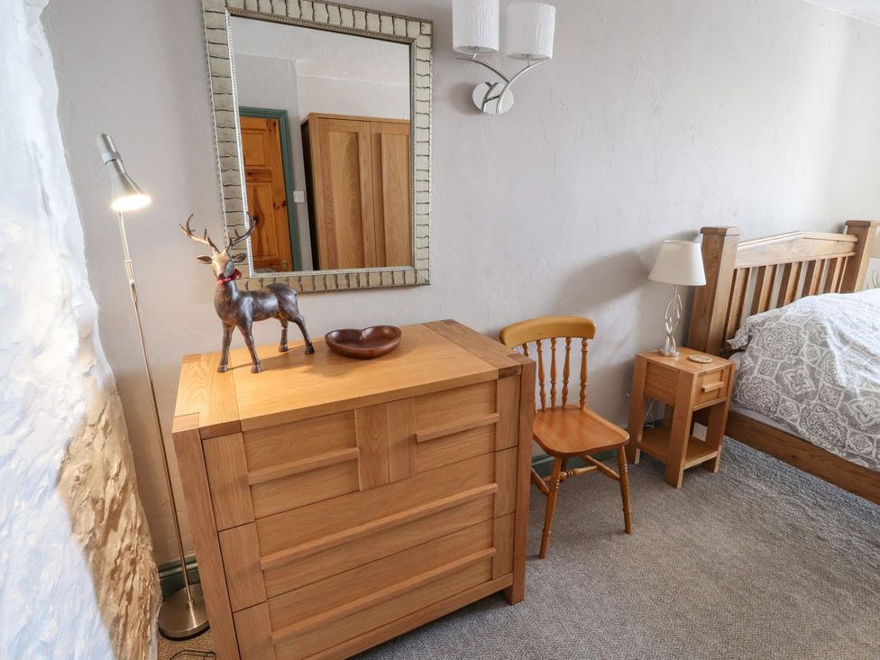 A bedroom with a chest of drawers and a bed at Mellfell Cottage near Watermillock