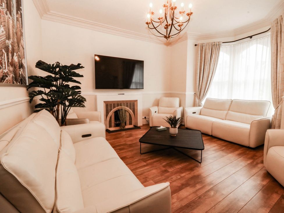 A living room with a television and sofa at Tudno Lodge in Llandudno