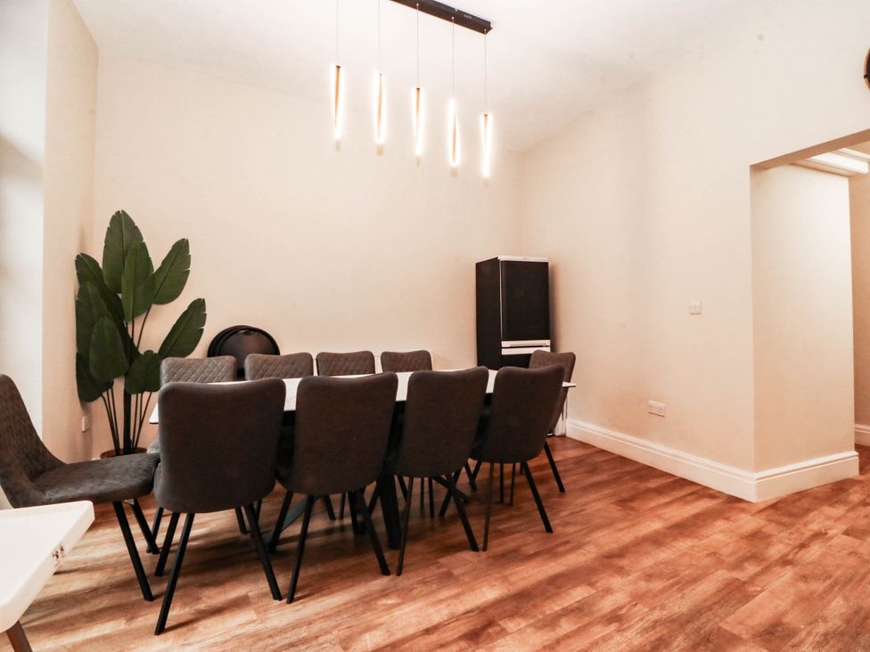 A dining room with a table and chairs at Tudno Lodge in Llandudno