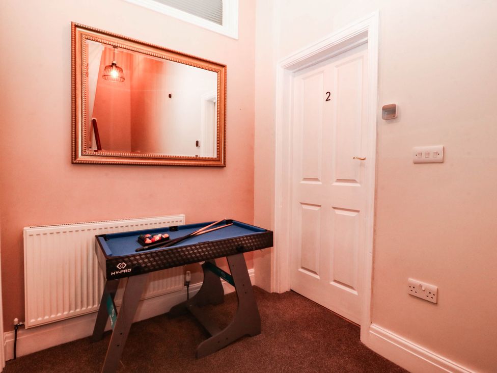 A hallway with a pool table and a mirror at Tudno Lodge in Llandudno
