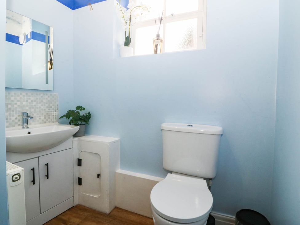 A bathroom with a sink and toilet at Tudno Lodge in Llandudno
