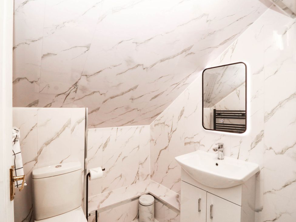 A bathroom with a sink and toilet at Tudno Lodge in Llandudno