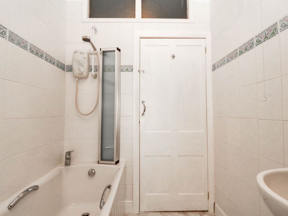 A bathroom with a bathtub and shower at Tudno Lodge in Llandudno
