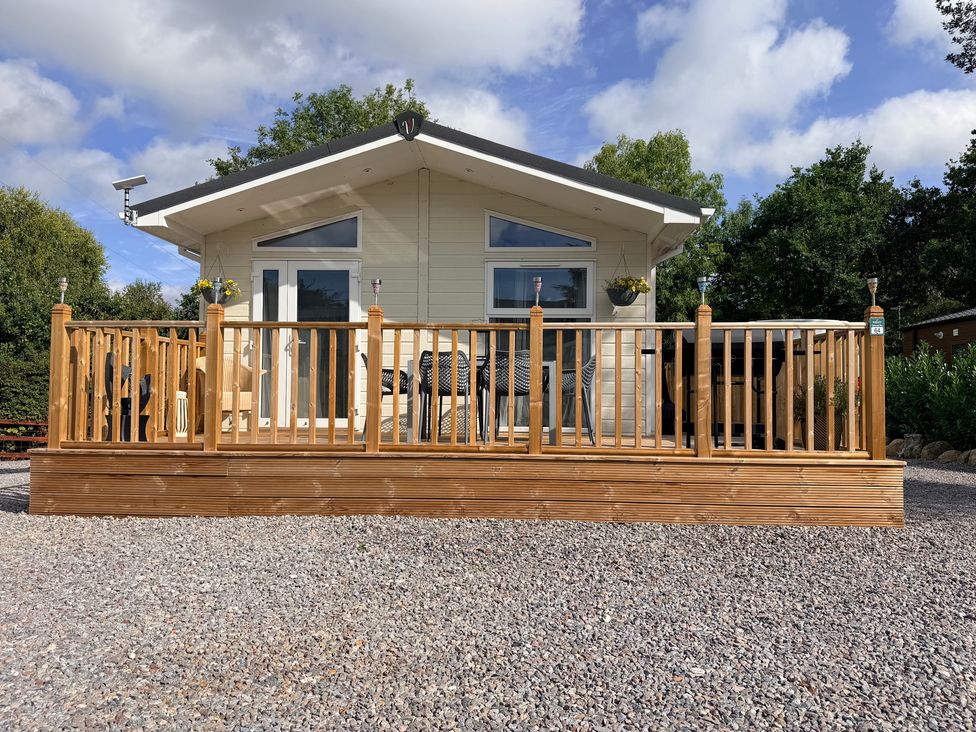 An outdoor deck with seating at Boutique Lodge in Cheriton Bishop
