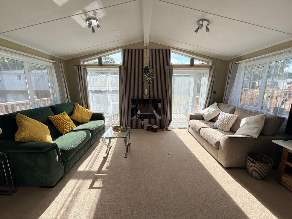 A living room with sofas and a fireplace at Boutique Lodge in Cheriton Bishop