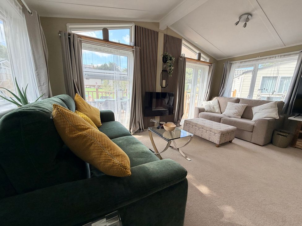 A living room with a sofa and coffee table at Boutique Lodge in Cheriton Bishop