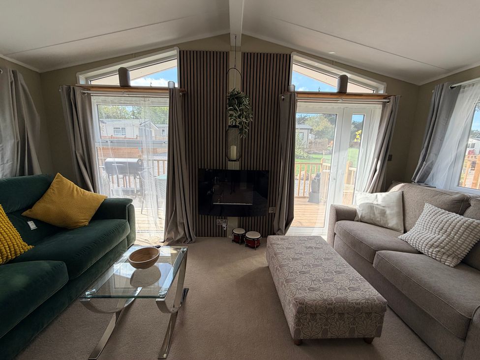 A living room with sofas and a coffee table at Boutique Lodge in Cheriton Bishop