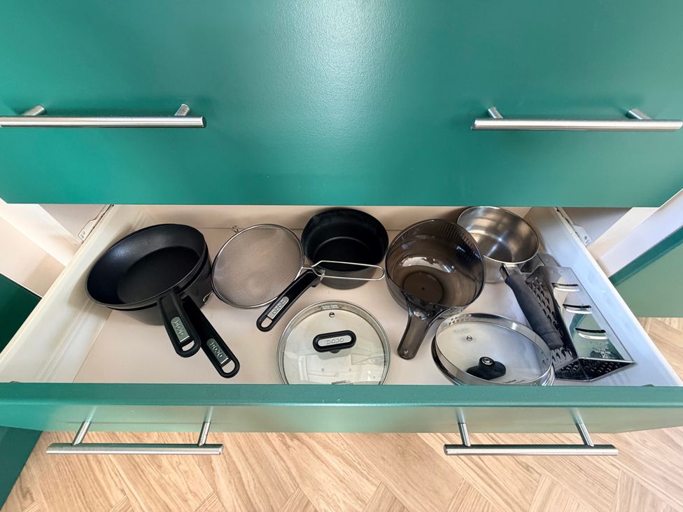 A kitchen drawer with various pots and kitchen tools at Boutique Lodge in Cheriton Bishop