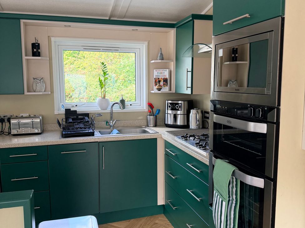 A kitchen with a sink and appliances at Boutique Lodge in Cheriton Bishop