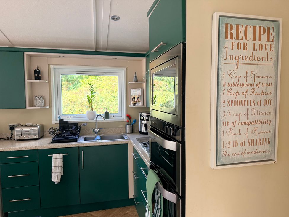 A kitchen with a sink and appliances at Boutique Lodge in Cheriton Bishop