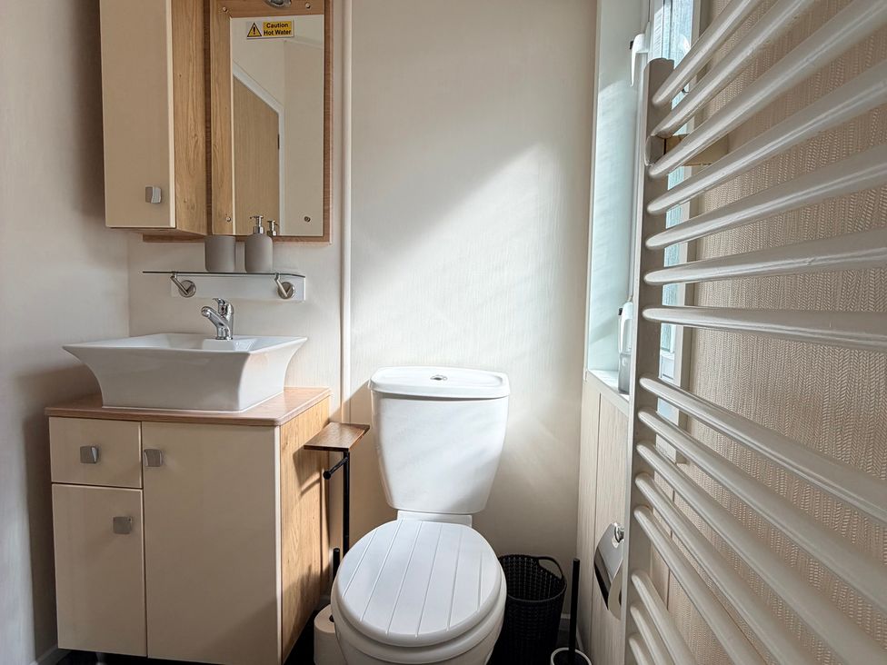 A bathroom with a sink and toilet at Boutique Lodge in Cheriton Bishop