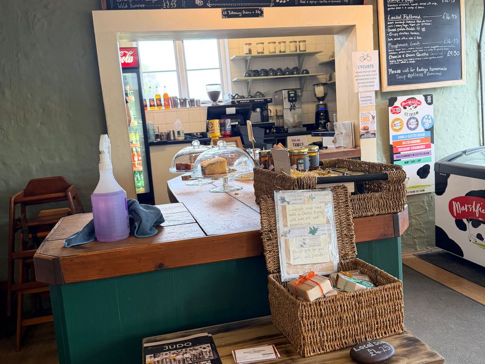 A café counter with cakes and drinks at Boutique Lodge in Cheriton Bishop