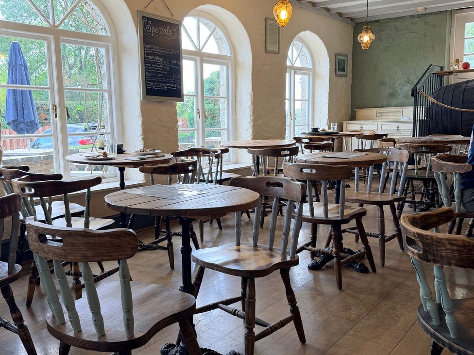 A dining room with tables and chairs at Boutique Lodge Cheriton Bishop
