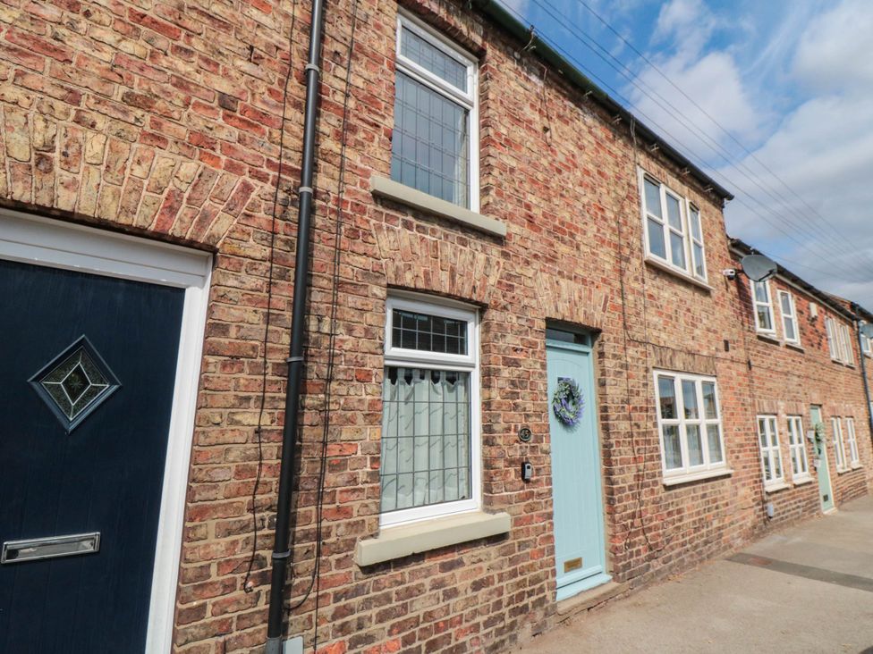 A brick exterior of a house with windows and entrance at 45 St. Hildas Street in Sherburn