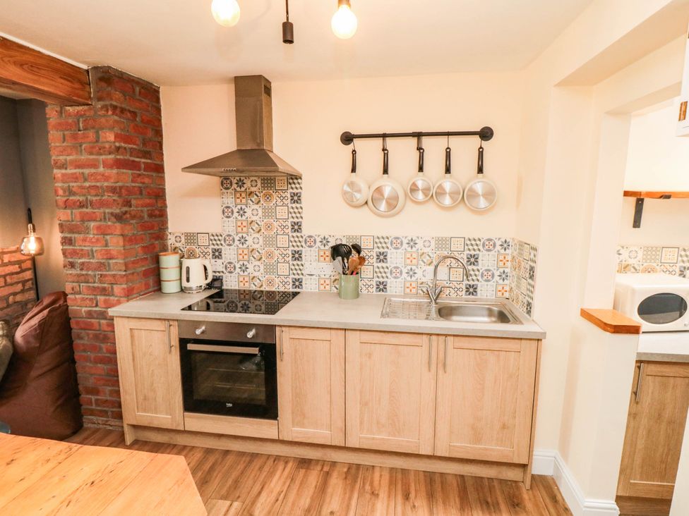 A kitchen with a stove and sink at 45 St. Hildas Street in Sherburn