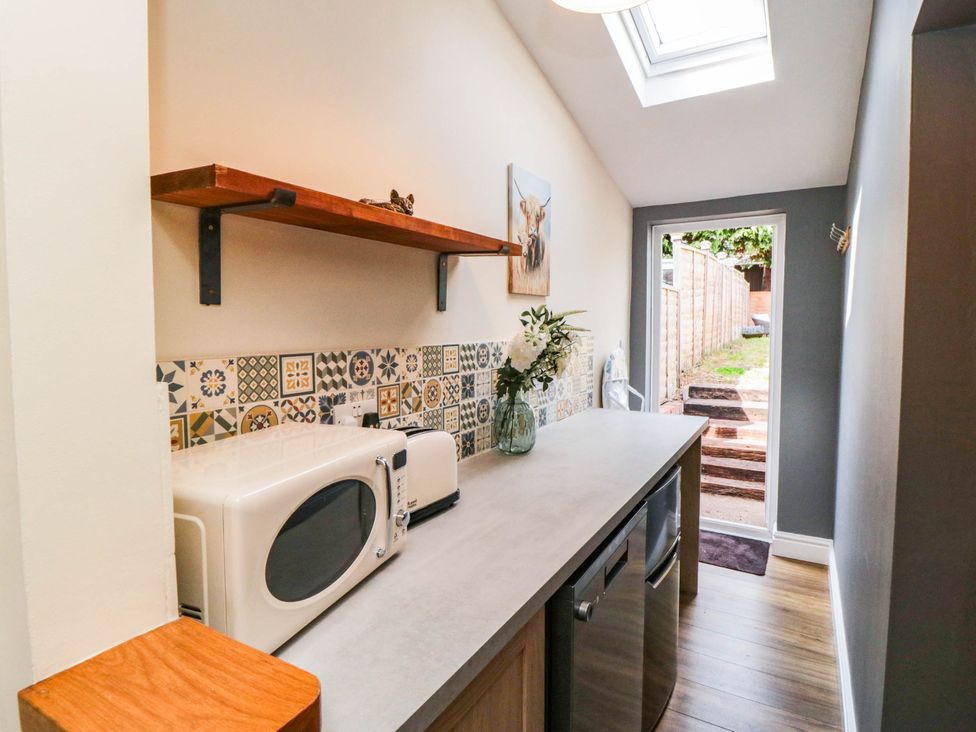 A kitchen with appliances and a door leading outside at 45 St. Hildas Street in Sherburn