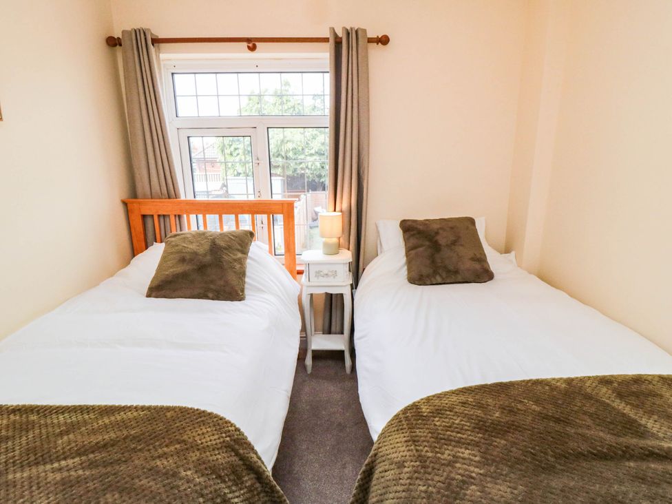 A bedroom with two beds and a bedside table at 45 St. Hildas Street in Sherburn