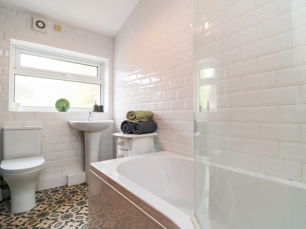 A bathroom with a toilet, sink, and a bathtub at 45 St. Hildas Street Sherburn