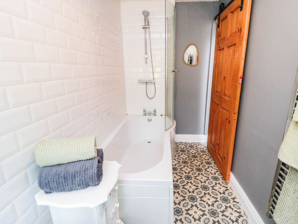 A bathroom with a shower and bathtub at 45 St. Hildas Street in Sherburn