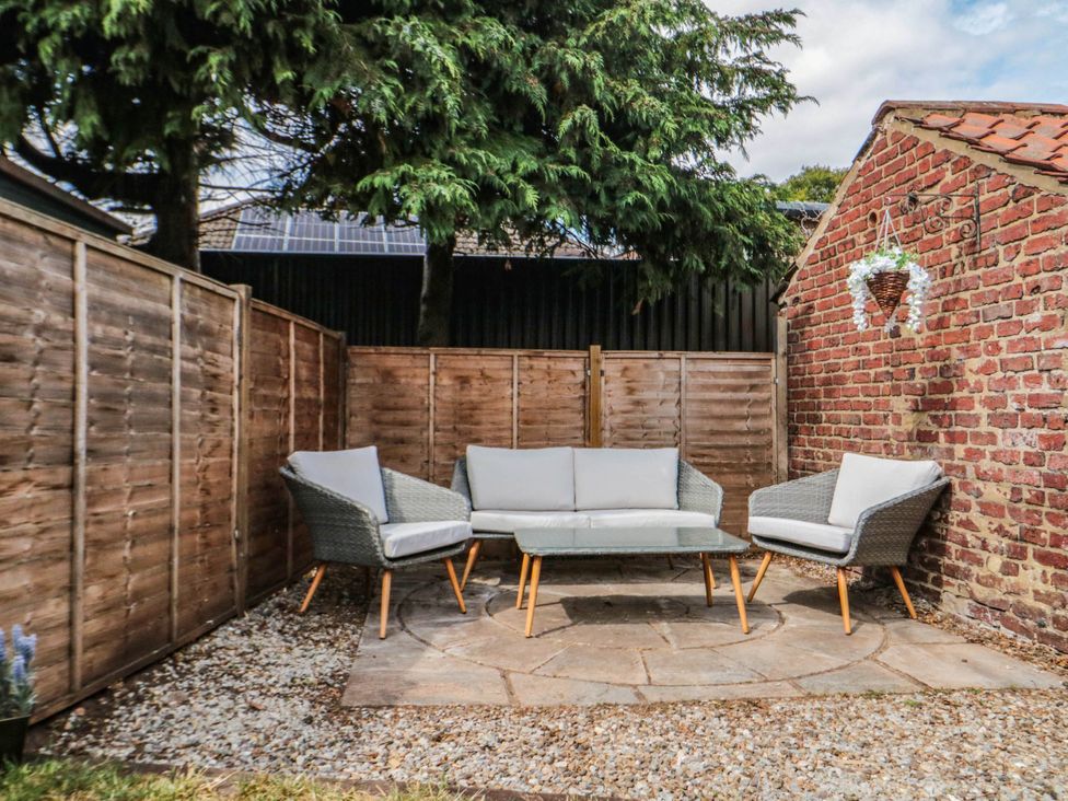 A garden setup with a sofa and chairs at 45 St. Hildas Street in Sherburn