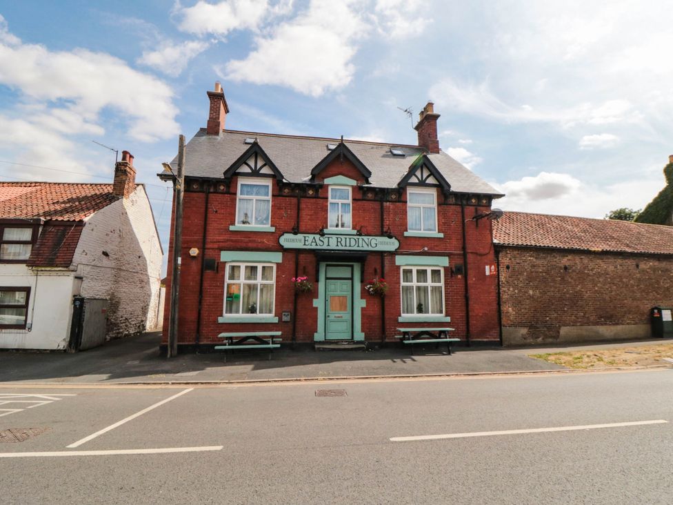 A pub building with signage and seating at 45 St. Hildas Street in Sherburn