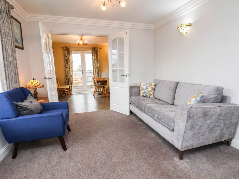 A living room with a sofa and armchair at 64 Derwent Road, Whitby