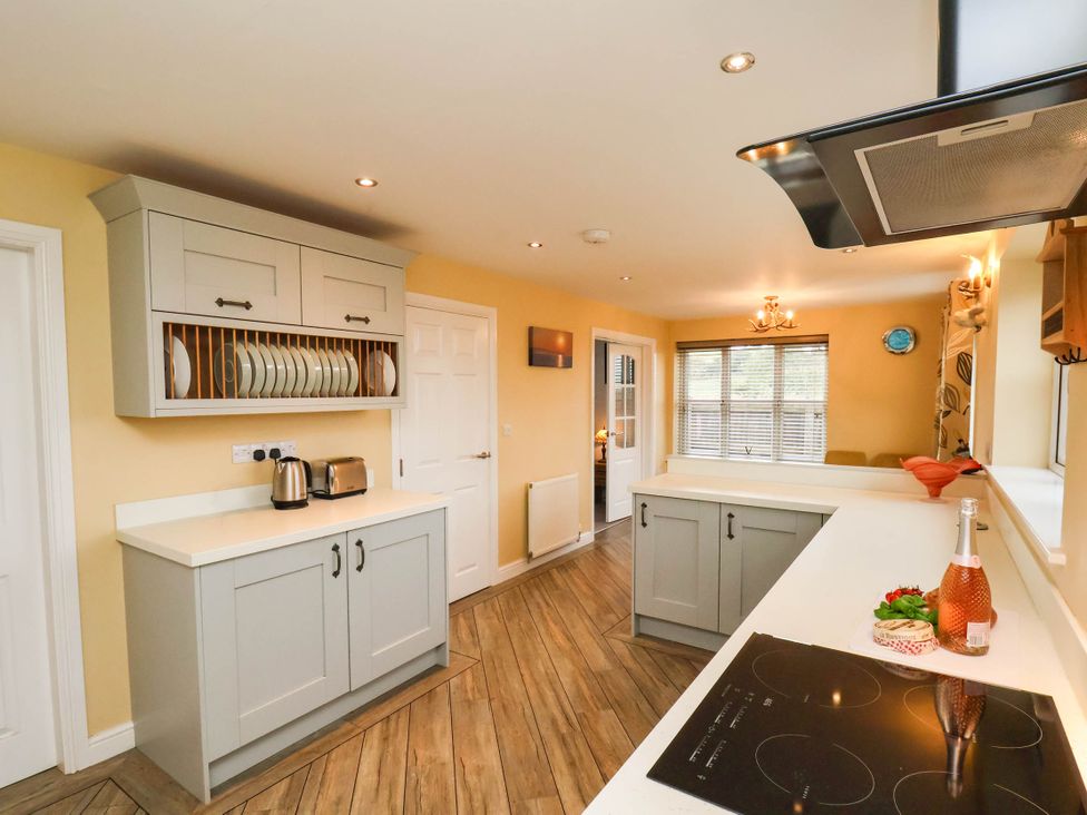 A kitchen with cabinets and countertop at 64 Derwent Road in Whitby