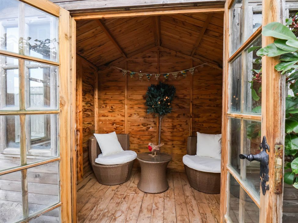 A garden room with seating and a table at 64 Derwent Road, Whitby