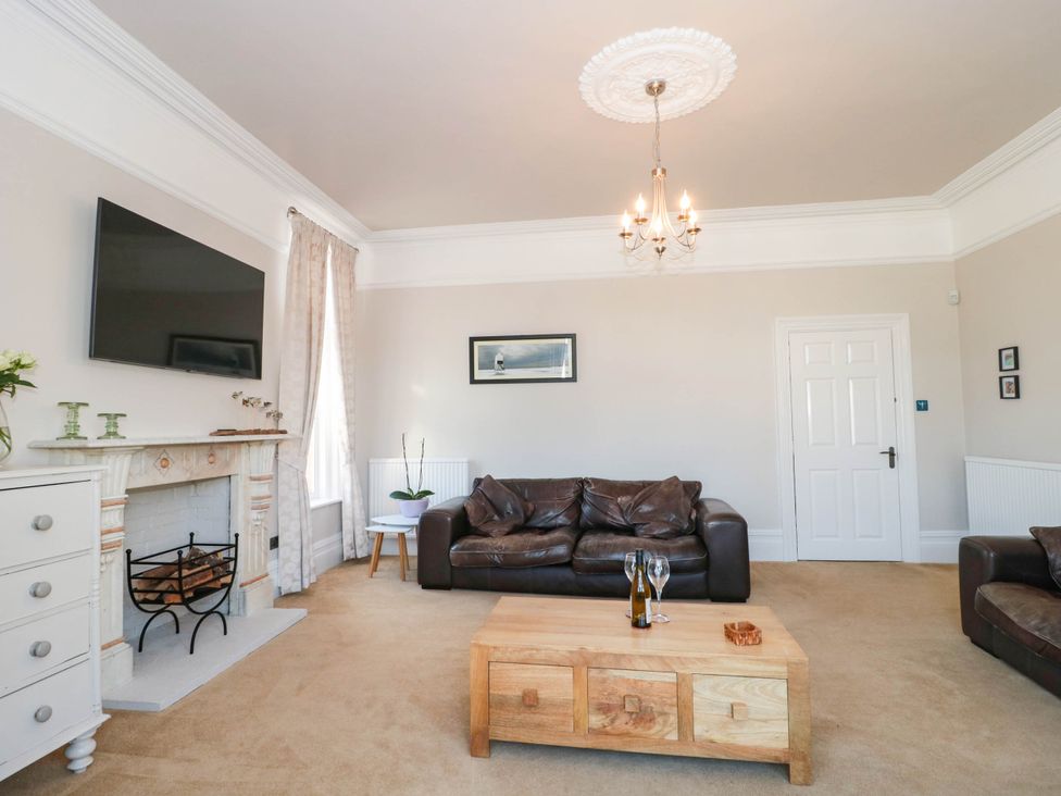 A living room with a television and sofa at Ashbourne House 