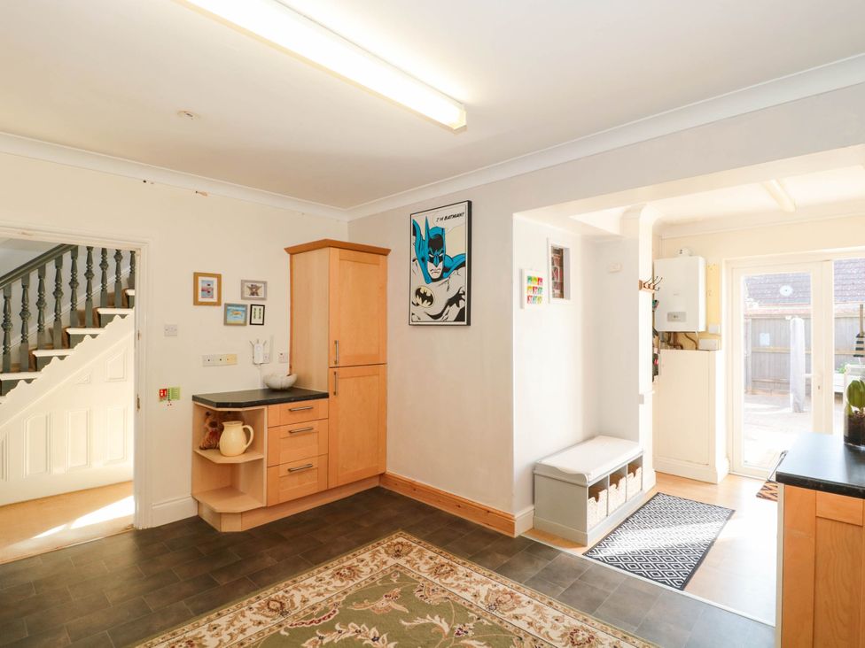 A kitchen with cabinets and stairs visible at Ashbourne House