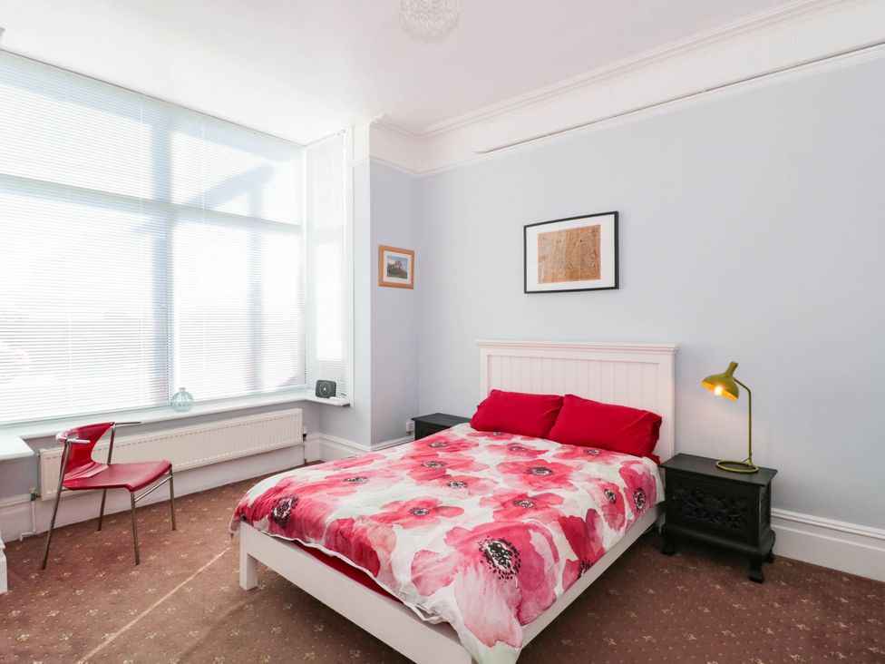 A bedroom with a bed and bedside table at Ashbourne House